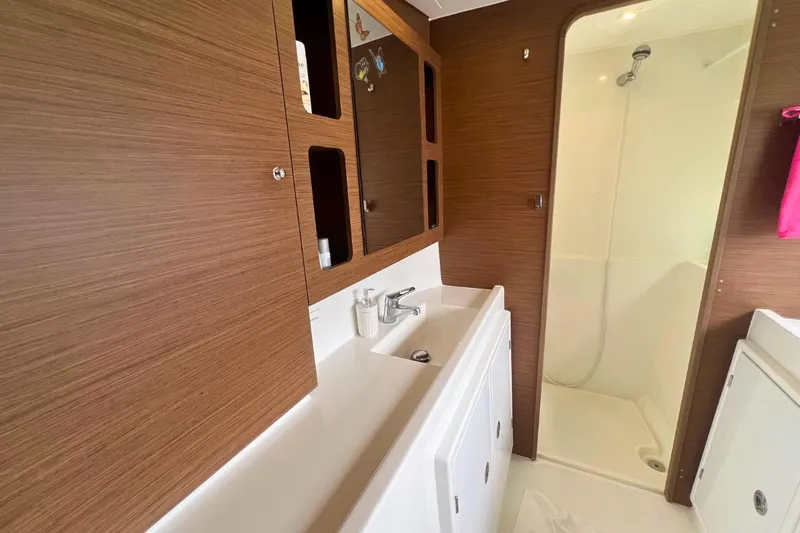 Ile En Ile Yacht Photos Pics Modern bathroom in 2018 Lagoon 42 yacht with wood cabinets and shower.