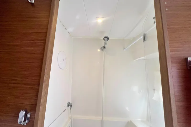Ile En Ile Yacht Photos Pics Shower area inside a 2018 Lagoon 42 catamaran, featuring a sleek, modern design.