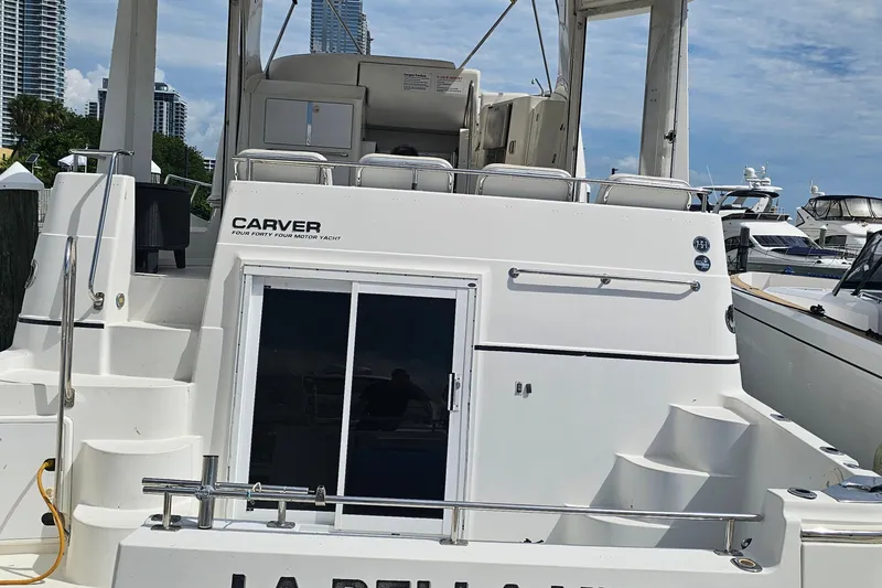 La Bella Vita Yacht Photos Pics 2004 Carver 444 Cockpit Motor Yacht docked, showcasing rear view and sleek design.