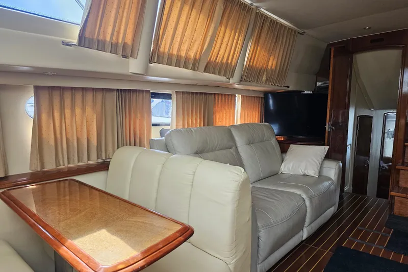 La Bella Vita Yacht Photos Pics Luxurious interior of 2004 Carver 444 Cockpit Motor Yacht with leather seating and wood accents.