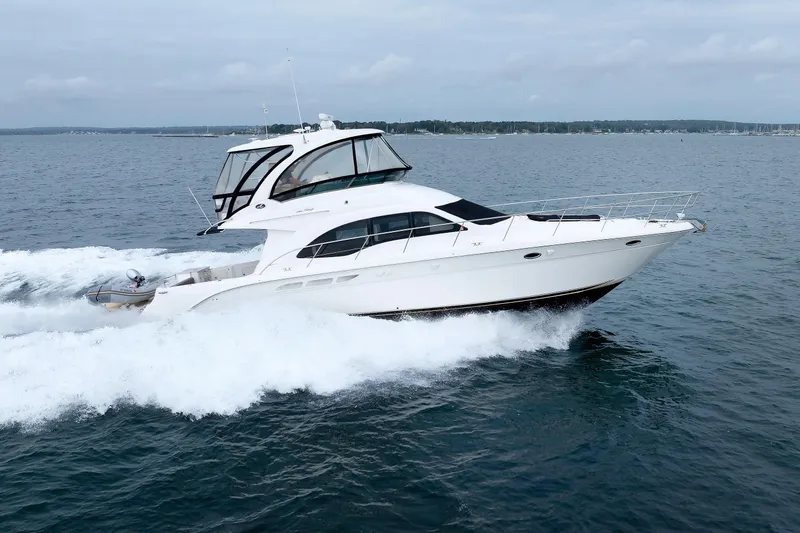  Yacht Photos Pics 2010 Sea Ray 520 Sedan Bridge yacht cruising on open water.
