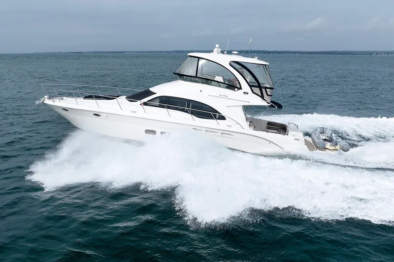  Yacht Photos Pics 2010 Sea Ray 520 Sedan Bridge yacht cruising on open water.