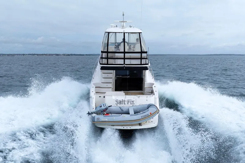  Yacht Photos Pics 2010 Sea Ray 520 Sedan Bridge cruising on open water, rear view.