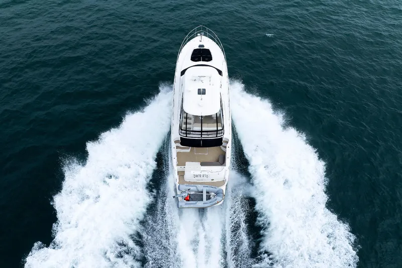  Yacht Photos Pics Aerial view of 2010 Sea Ray 520 Sedan Bridge yacht cruising on open water.