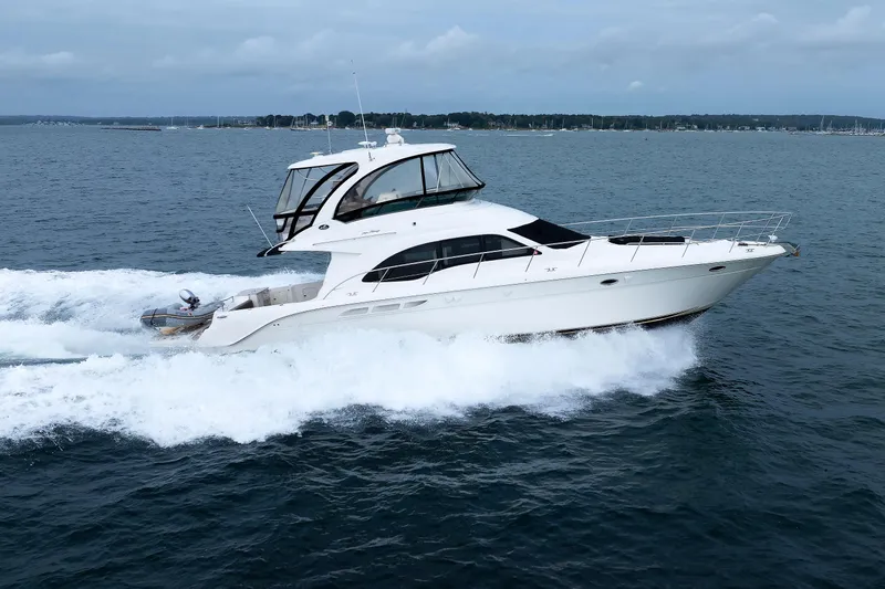  Yacht Photos Pics 2010 Sea Ray 520 Sedan Bridge yacht cruising on open water.