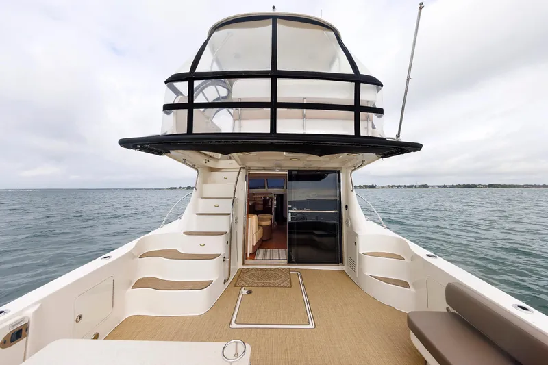  Yacht Photos Pics 2010 Sea Ray 520 Sedan Bridge yacht on open water, showcasing spacious deck and elegant design.