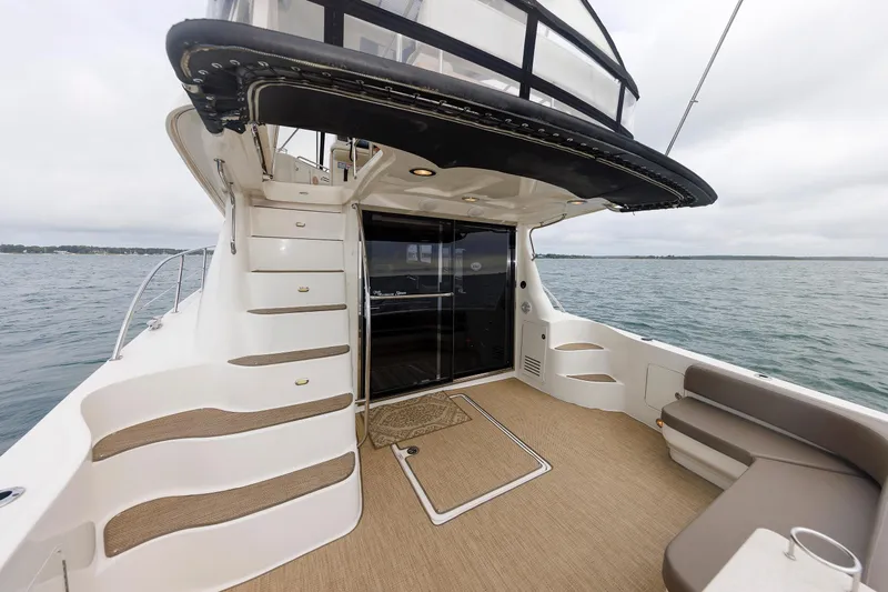  Yacht Photos Pics 2010 Sea Ray 520 Sedan Bridge yacht deck with stairs and seating, overlooking the ocean.