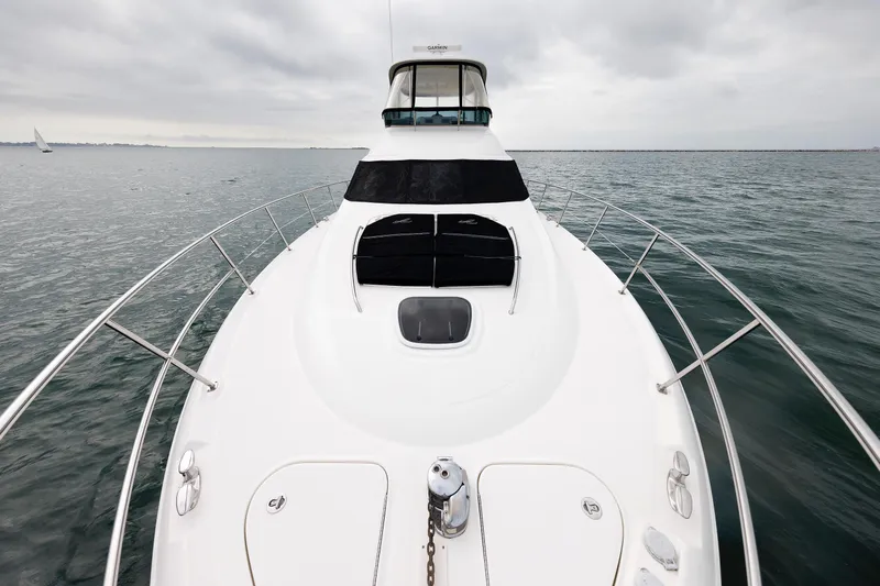  Yacht Photos Pics 2010 Sea Ray 520 Sedan Bridge yacht on open water, showcasing sleek design and spacious deck.