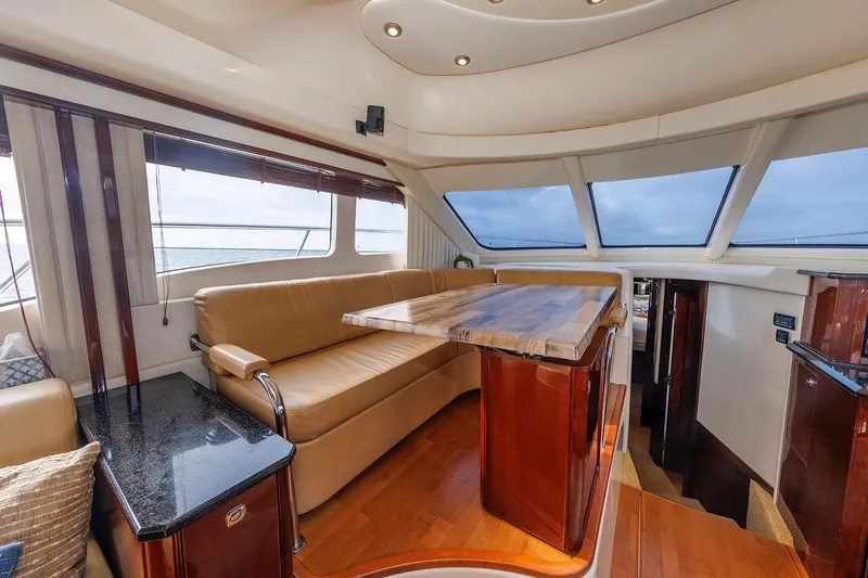  Yacht Photos Pics Luxurious interior of 2010 Sea Ray 520 Sedan Bridge yacht with elegant seating and panoramic windows.