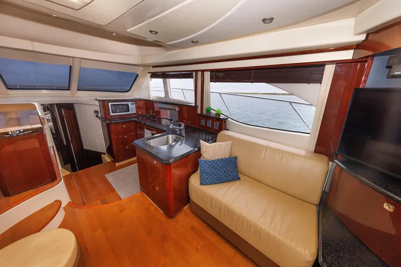  Yacht Photos Pics Luxurious interior of 2010 Sea Ray 520 Sedan Bridge yacht with modern kitchen and seating area.