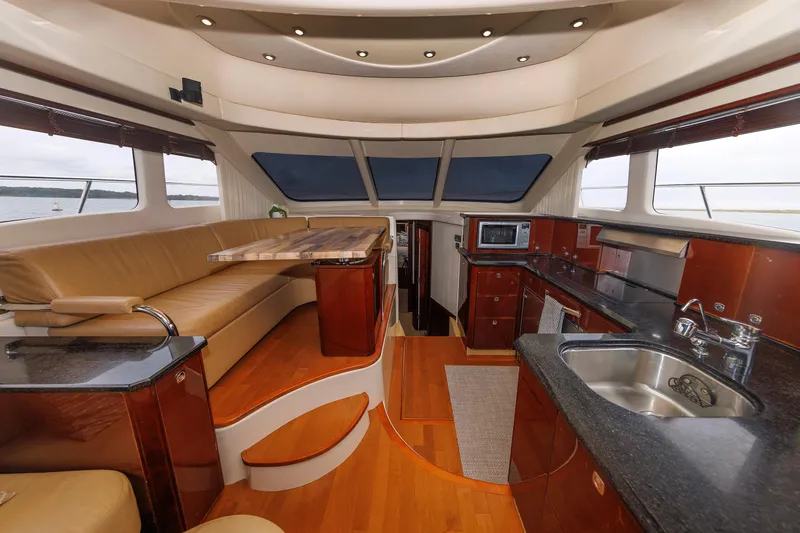  Yacht Photos Pics Luxurious interior of 2010 Sea Ray 520 Sedan Bridge yacht with modern kitchen and seating area.
