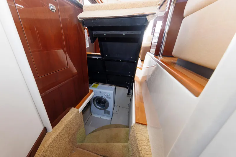 Yacht Photos Pics 2010 Sea Ray 520 Sedan Bridge interior with hidden laundry area and wooden finishes.