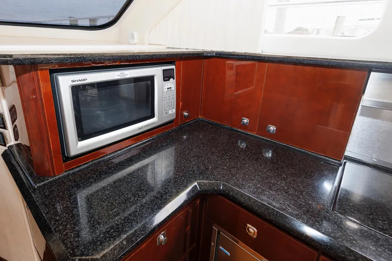  Yacht Photos Pics Luxurious kitchen area in 2010 Sea Ray 520 Sedan Bridge yacht with microwave.