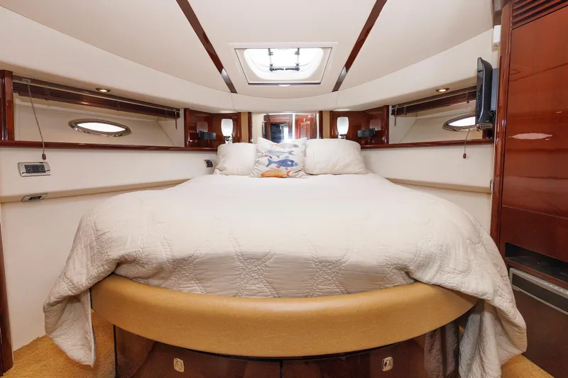 Yacht Photos Pics Luxurious bedroom interior of 2010 Sea Ray 520 Sedan Bridge yacht, featuring a cozy bed.