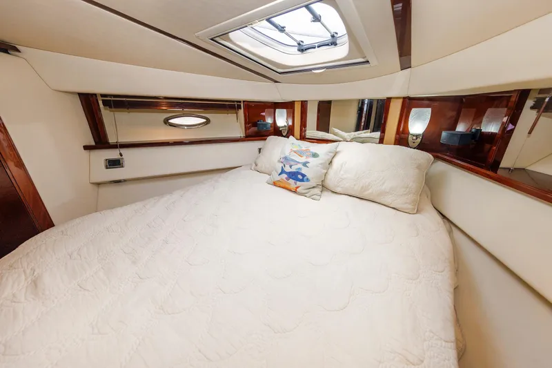  Yacht Photos Pics Luxurious bedroom interior of 2010 Sea Ray 520 Sedan Bridge yacht with plush bedding.