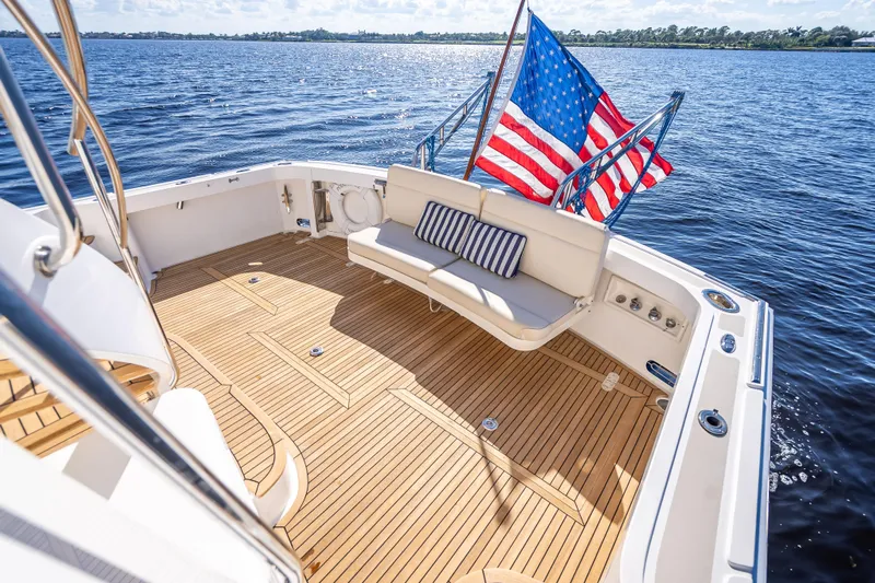Persistence Yacht Photos Pics 2008 Grand Banks 47 Eastbay FB yacht with teak deck and American flag on open water.
