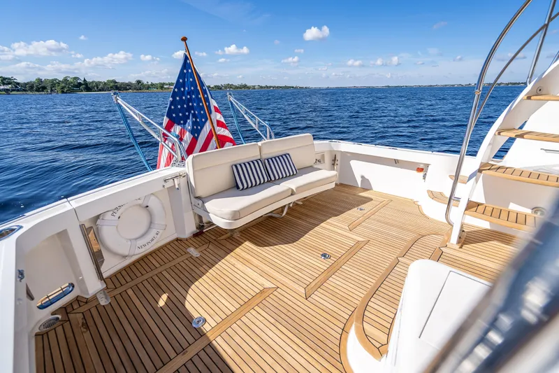 Persistence Yacht Photos Pics 2008 Grand Banks 47 Eastbay FB yacht deck with seating, American flag, and ocean view.