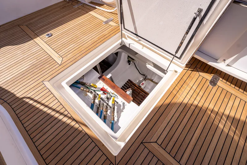 Persistence Yacht Photos Pics Open hatch on 2008 Grand Banks 47 Eastbay FB, revealing storage and equipment.