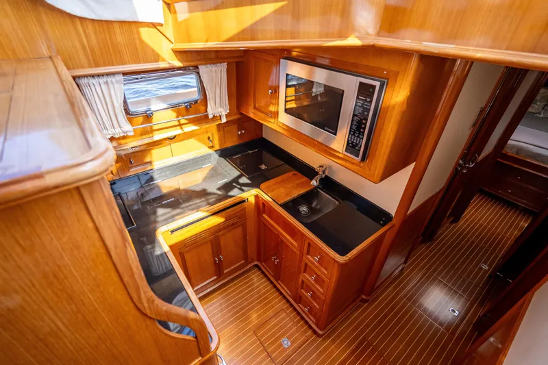 Persistence Yacht Photos Pics Luxurious 2008 Grand Banks 47 Eastbay FB yacht kitchen with wood cabinetry and modern appliances.