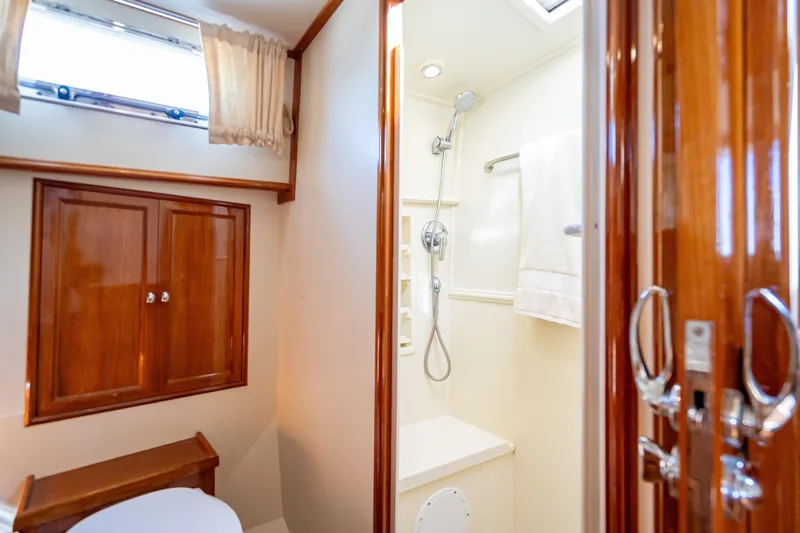 Persistence Yacht Photos Pics Luxurious bathroom in 2008 Grand Banks 47 Eastbay FB yacht with wooden cabinetry and shower.