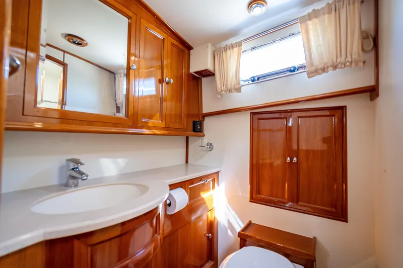 Persistence Yacht Photos Pics Luxurious 2008 Grand Banks 47 Eastbay FB yacht bathroom with wooden cabinetry and modern fixtures.