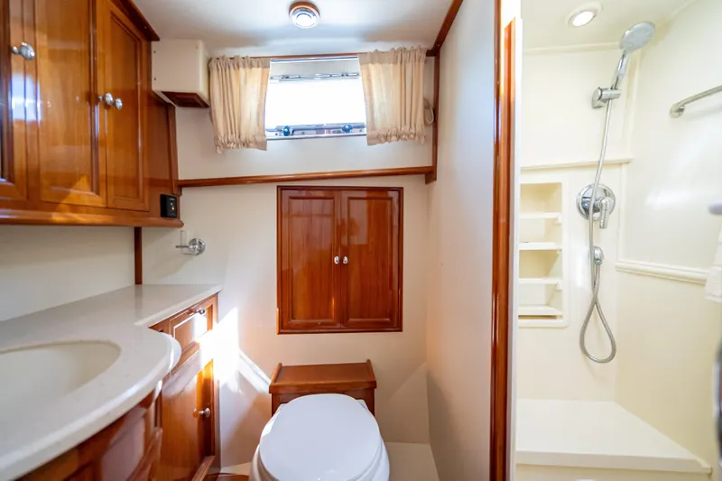 Persistence Yacht Photos Pics Luxurious bathroom in 2008 Grand Banks 47 Eastbay FB yacht with wood cabinetry and shower.