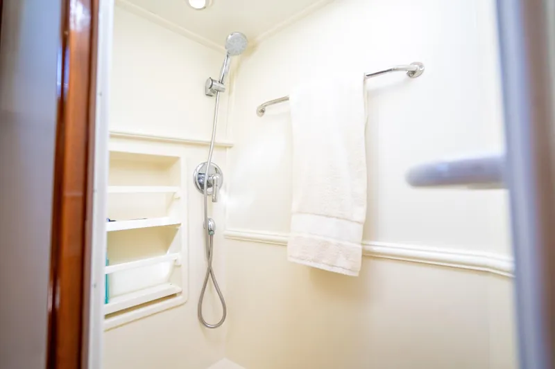 Persistence Yacht Photos Pics Shower area in 2008 Grand Banks 47 Eastbay FB yacht, featuring towel and shelves.