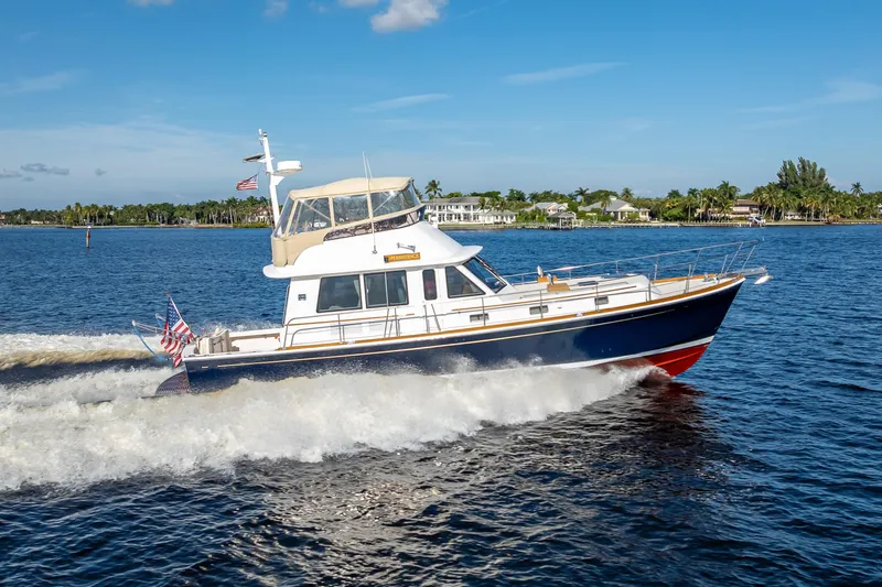 Persistence Yacht Photos Pics 2008 Grand Banks 47 Eastbay FB cruising on a sunny day, displaying American flags.