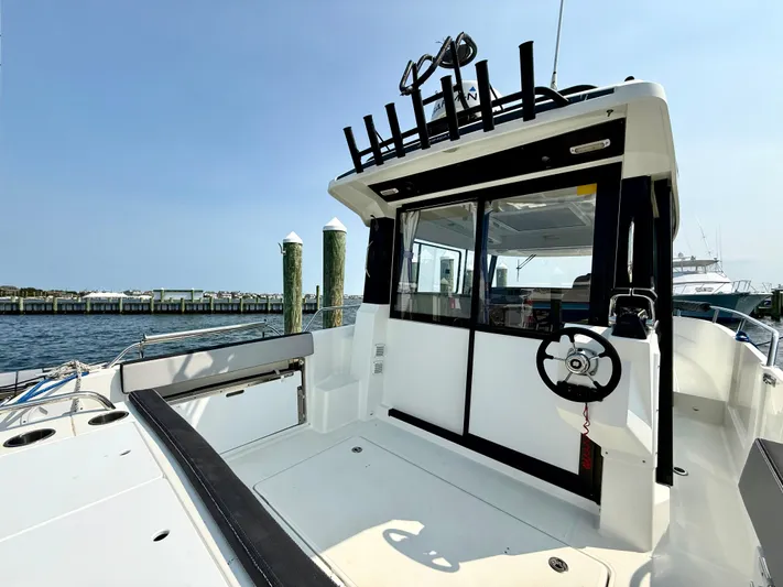  Yacht Photos Pics 2020 Jeanneau NC Sport 895 boat docked, featuring spacious deck and modern design.