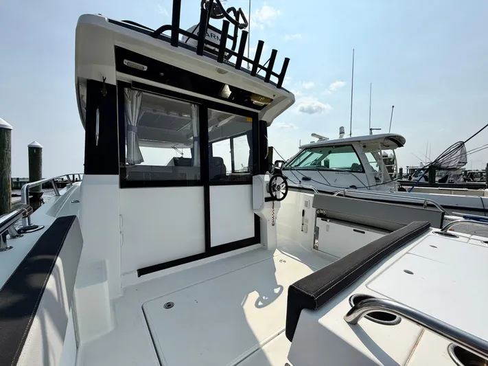  Yacht Photos Pics 2020 Jeanneau NC Sport 895 boat, rear deck view with seating and steering wheel.