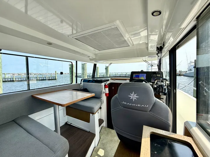  Yacht Photos Pics Interior of 2020 Jeanneau NC Sport 895 boat, featuring seating and helm station.