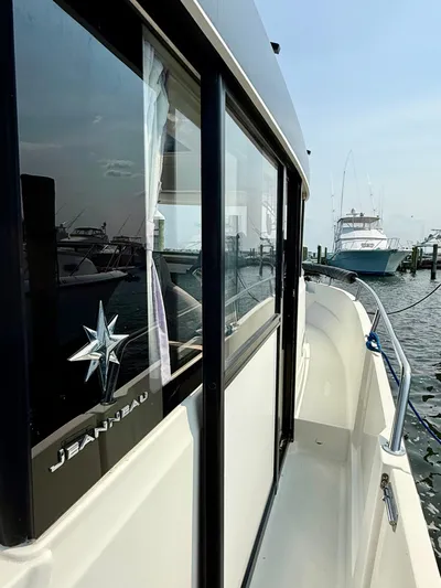  Yacht Photos Pics 2020 Jeanneau NC Sport 895 docked at marina, showcasing sleek design and window details.