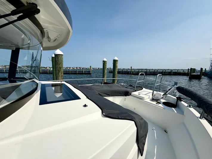  Yacht Photos Pics 2020 Jeanneau NC Sport 895 boat docked at a marina with clear skies.