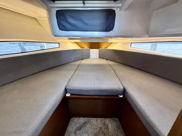  Yacht Photos Pics 2020 Jeanneau NC Sport 895 cabin interior with gray seating and windows.