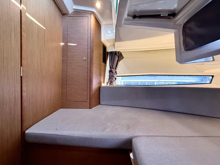  Yacht Photos Pics Interior cabin of 2020 Jeanneau NC Sport 895 with modern wood finish and seating.