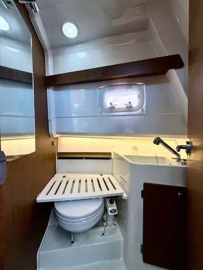  Yacht Photos Pics 2020 Jeanneau NC Sport 895 bathroom with compact design and modern fixtures.