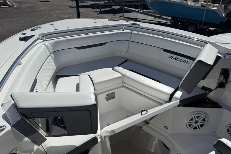  Yacht Photos Pics 2022 Blackfin 272 CC boat interior with white cushioned seating and sleek design.