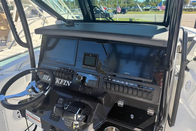  Yacht Photos Pics 2022 Blackfin 272 CC boat dashboard with steering wheel and navigation screens.