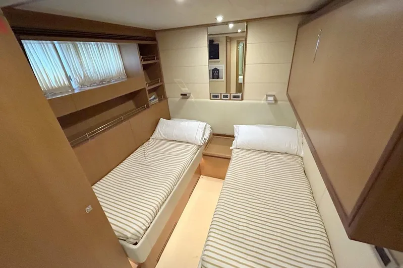 M/y Argo Yacht Photos Pics Twin cabin interior of 2006 Ferretti Yachts 780 with striped bedding and wooden finishes.