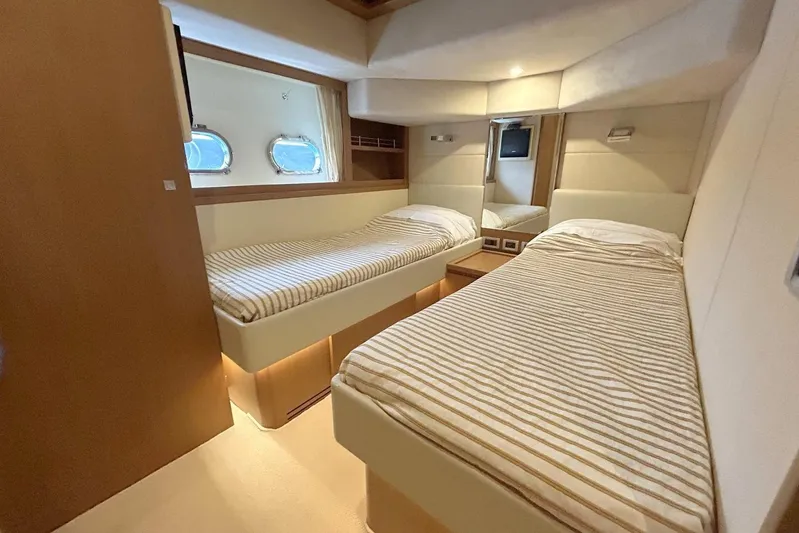 M/y Argo Yacht Photos Pics Luxurious twin cabin interior of 2006 Ferretti Yachts 780 with striped bedding.