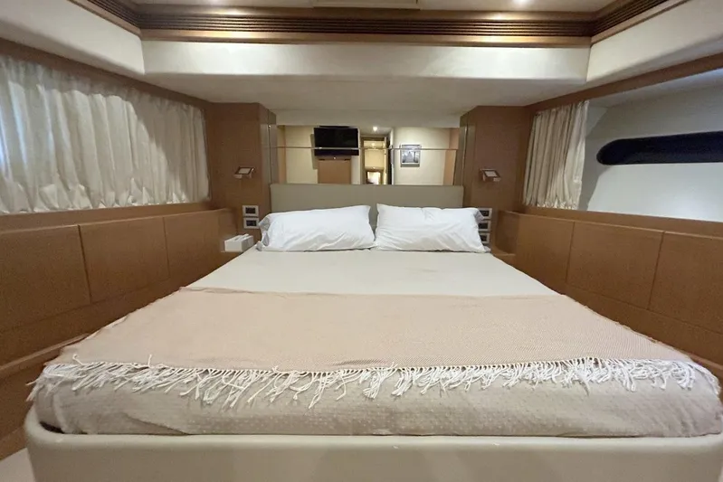 M/y Argo Yacht Photos Pics Luxurious bedroom interior of a 2006 Ferretti Yachts 780 with elegant bedding and wood paneling.