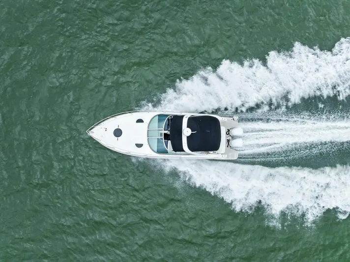 Snuffleupagus Yacht Photos Pics Aerial view of 2020 Regal 33 XO boat cruising on water.