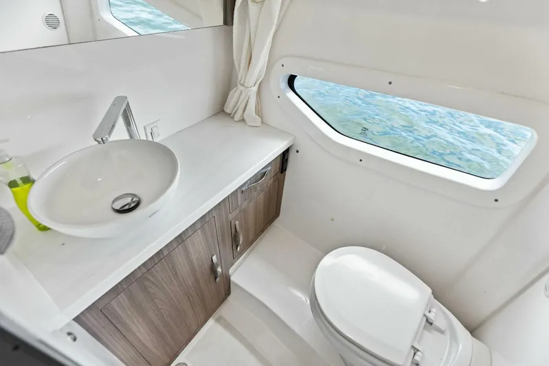Snuffleupagus Yacht Photos Pics Luxurious bathroom interior of 2020 Regal 33 XO yacht with ocean view window.