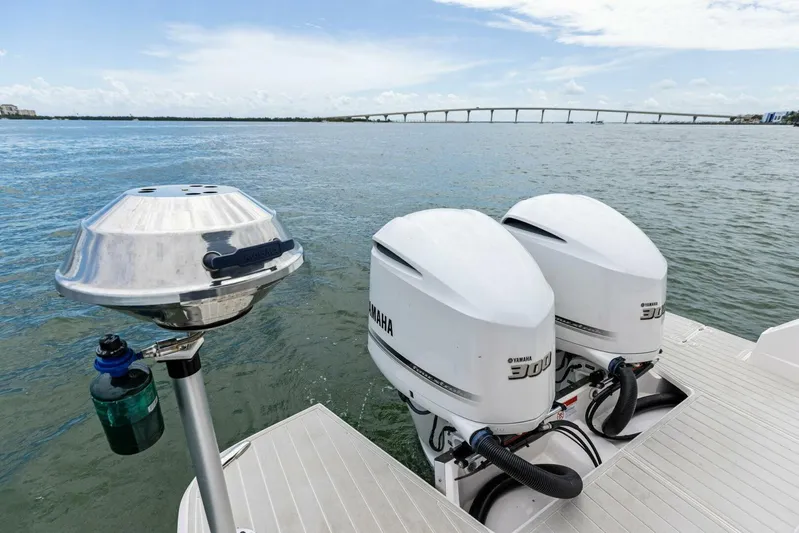 Snuffleupagus Yacht Photos Pics 2020 Regal 33 XO boat with dual Yamaha 300 engines on a calm waterway.