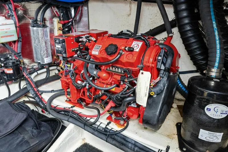 Snuffleupagus Yacht Photos Pics Engine compartment of a 2020 Regal 33 XO boat, featuring a red engine and various components.