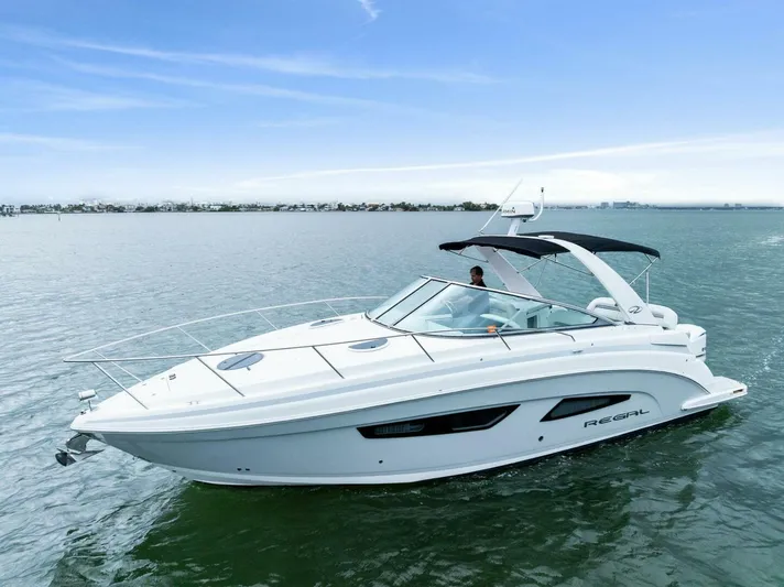 Snuffleupagus Yacht Photos Pics 2020 Regal 33 XO boat cruising on calm waters under a clear sky.