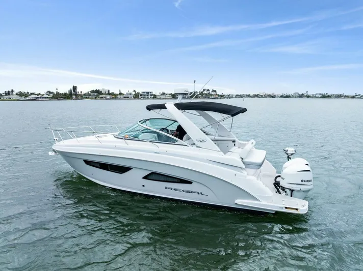 Snuffleupagus Yacht Photos Pics 2020 Regal 33 XO boat on calm water with clear sky background.