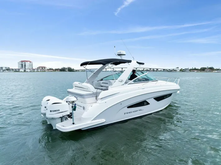 Snuffleupagus Yacht Photos Pics 2020 Regal 33 XO boat cruising on calm waters under a clear blue sky.