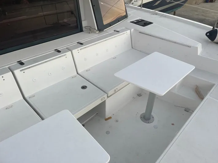  Yacht Photos Pics Spacious seating area on a 2019 Bali 4.3 catamaran with white tables and benches.