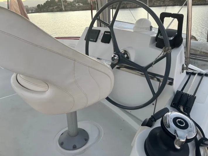  Yacht Photos Pics Steering wheel and seat on a 2019 Bali 4.3 catamaran, overlooking calm waters.